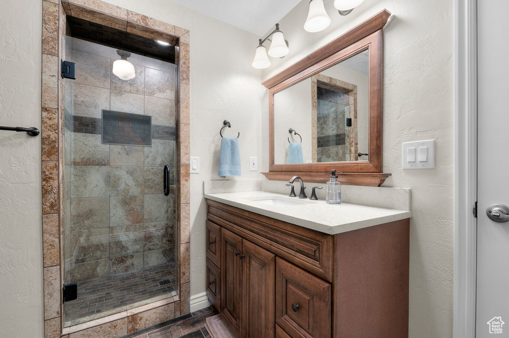 Full bath featuring vanity and a shower stall