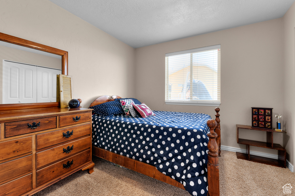 Bedroom featuring light colored carpet and baseboards