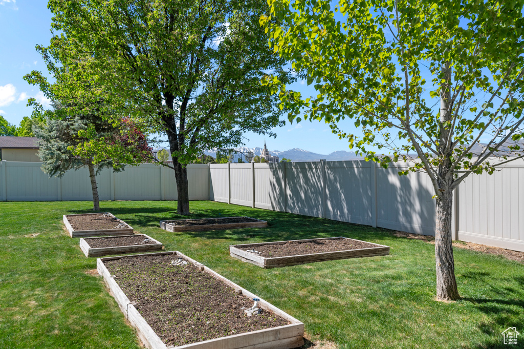 View of yard with a fenced backyard and a vegetable garden