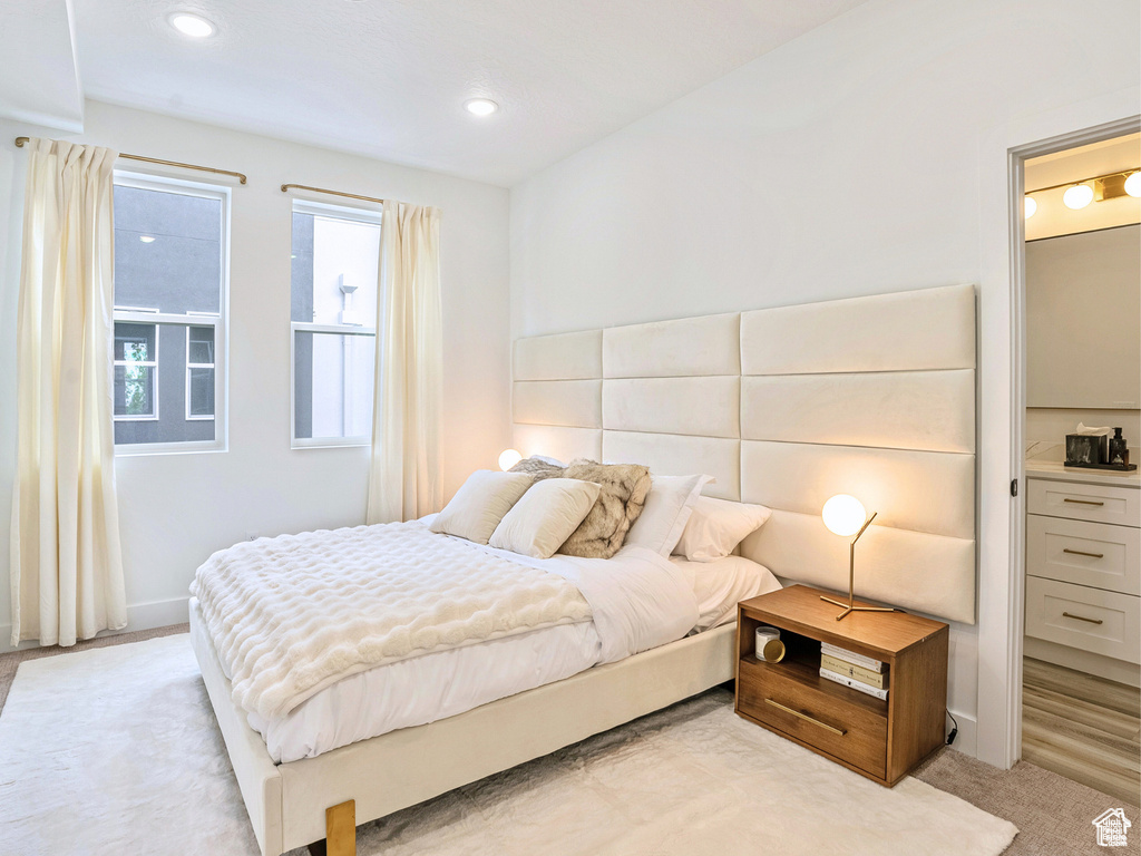 Bedroom featuring light carpet and recessed lighting