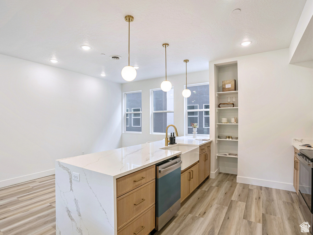 Kitchen featuring a peninsula, light brown cabinets, a sink, light wood-style flooring, and dishwasher
