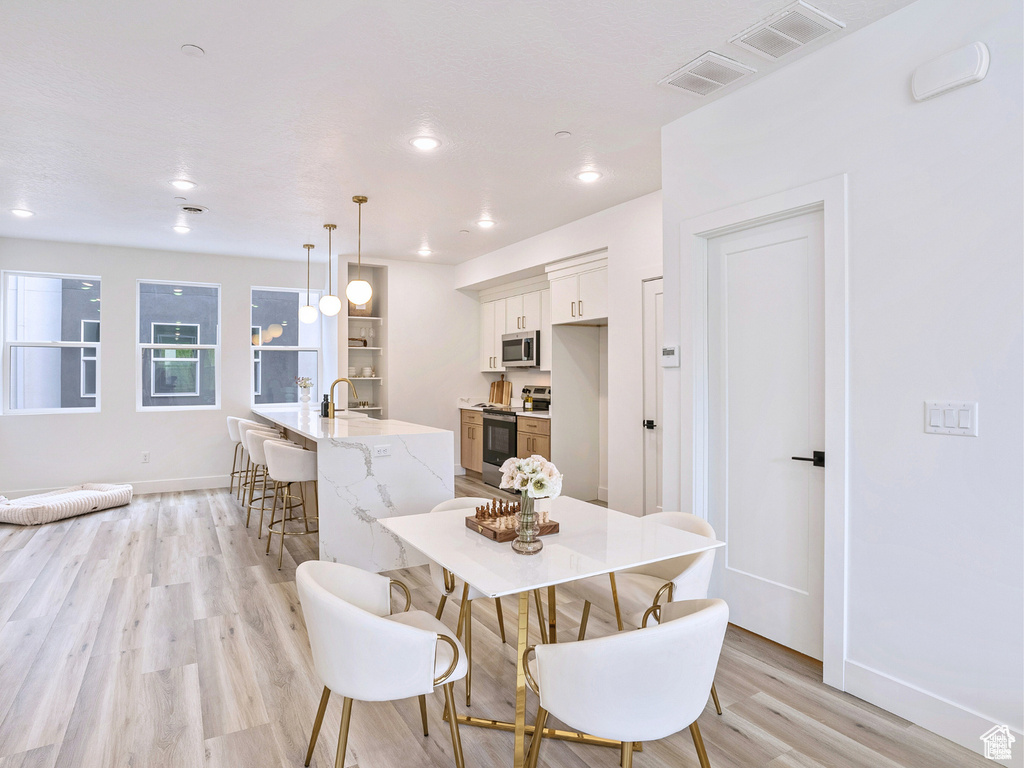 Dining area with recessed lighting, baseboards, light wood-type flooring, and visible vents