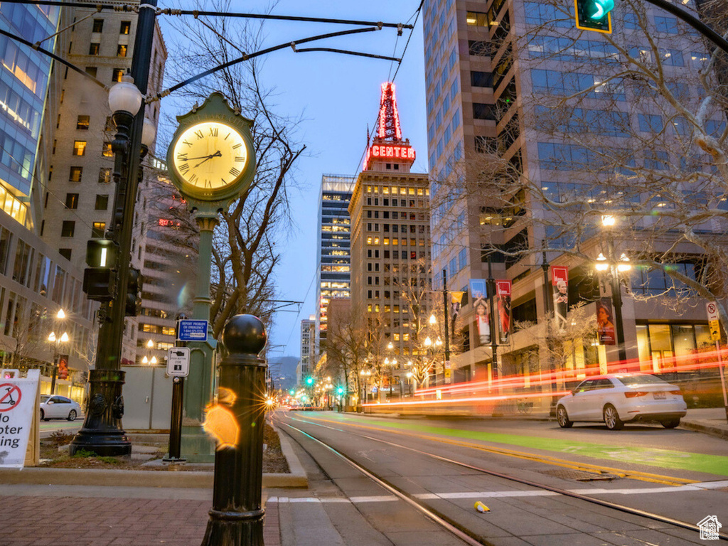 View of road with street lights, a city view, and sidewalks