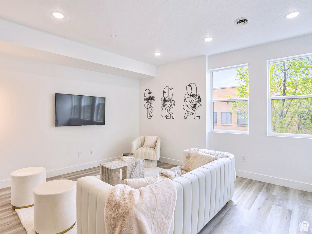 Living room with visible vents, recessed lighting, light wood finished floors, and baseboards
