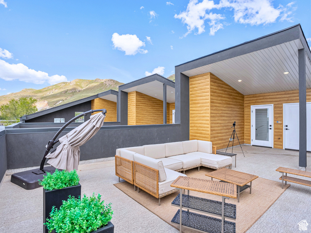 View of patio with an outdoor living space and a mountain view