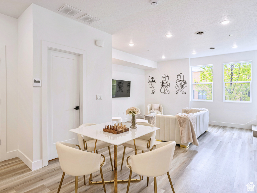 Dining room with recessed lighting, baseboards, light wood-type flooring, and visible vents