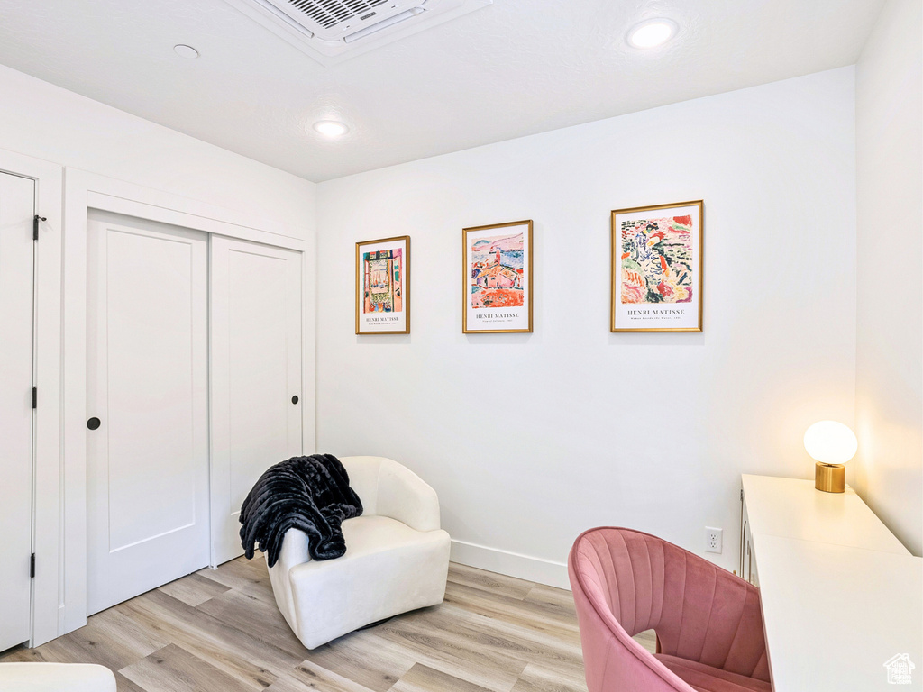 Living area featuring light wood-type flooring, recessed lighting, and baseboards