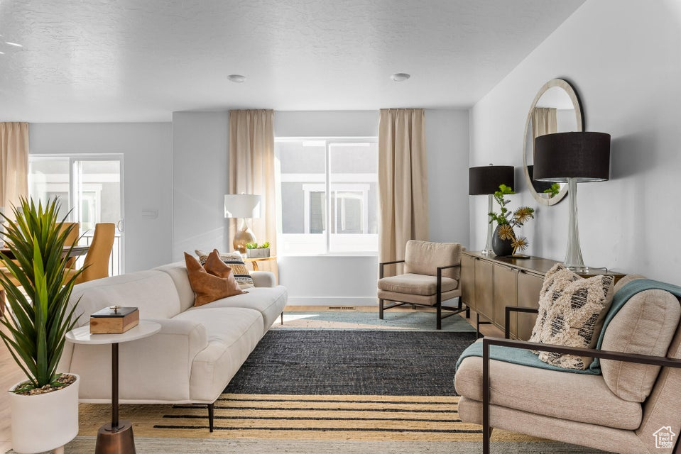 Living room with a textured ceiling and wood finished floors