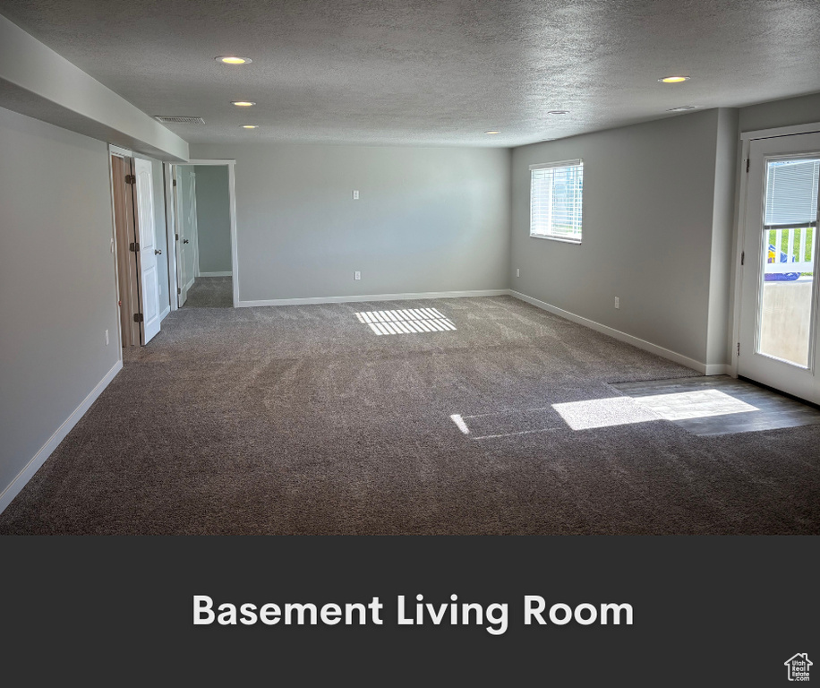 Empty room with carpet flooring, a textured ceiling, baseboards, and recessed lighting