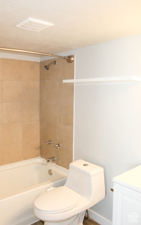 Full bathroom with toilet, visible vents, and bathtub / shower combination