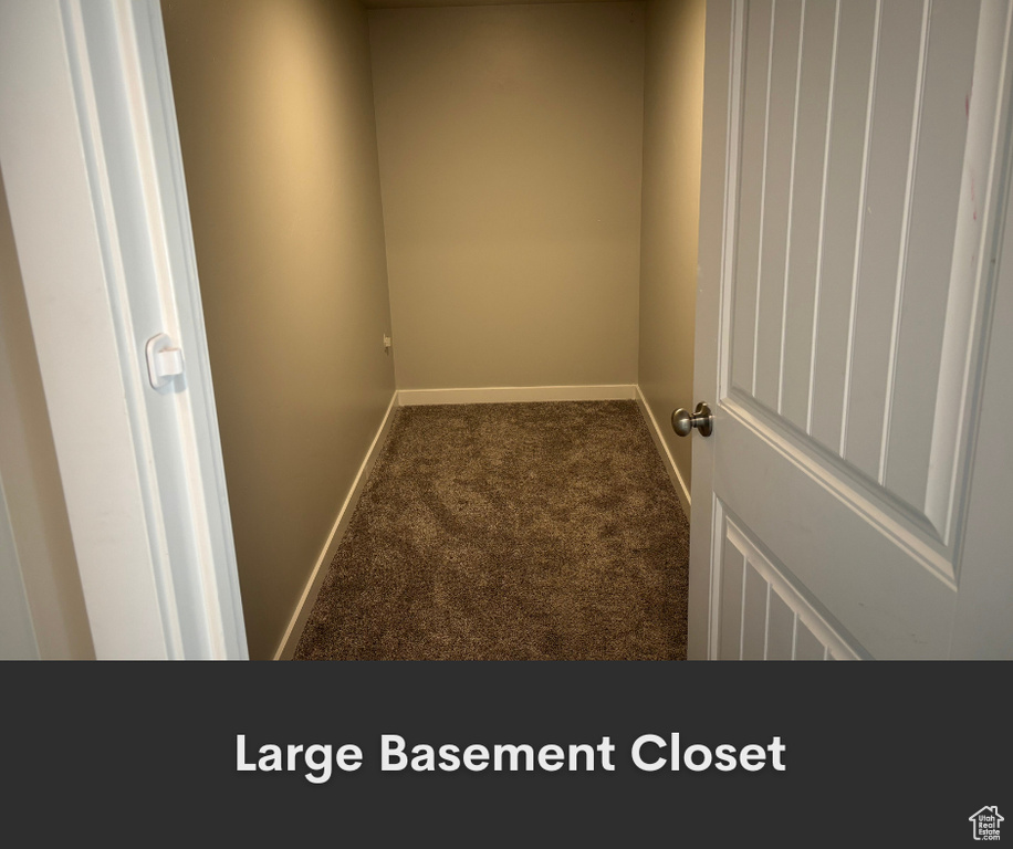 Empty room featuring carpet flooring and baseboards