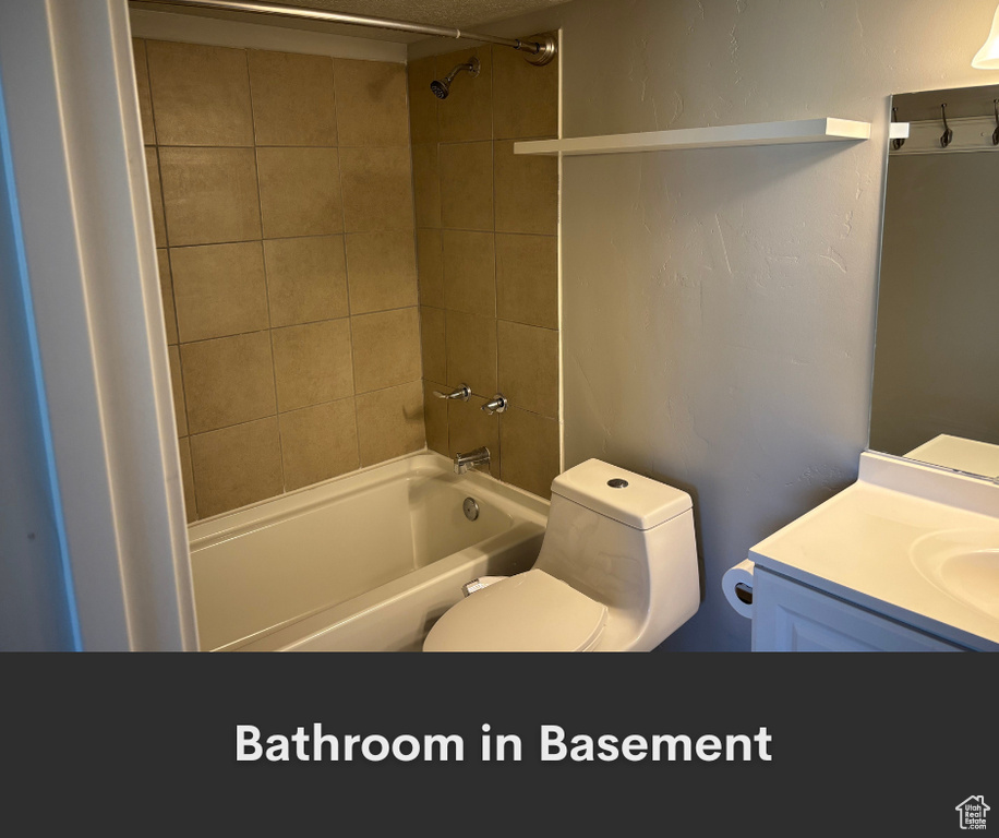 Full bath featuring bathing tub / shower combination, toilet, and vanity