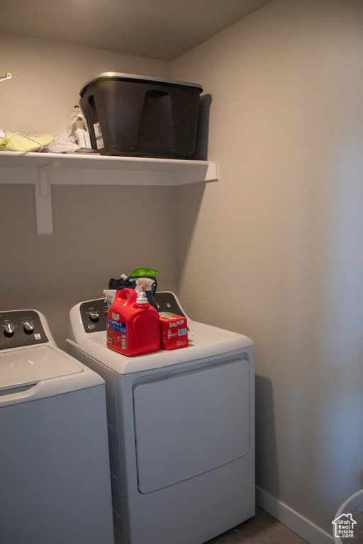 Laundry room with laundry area and washer and clothes dryer