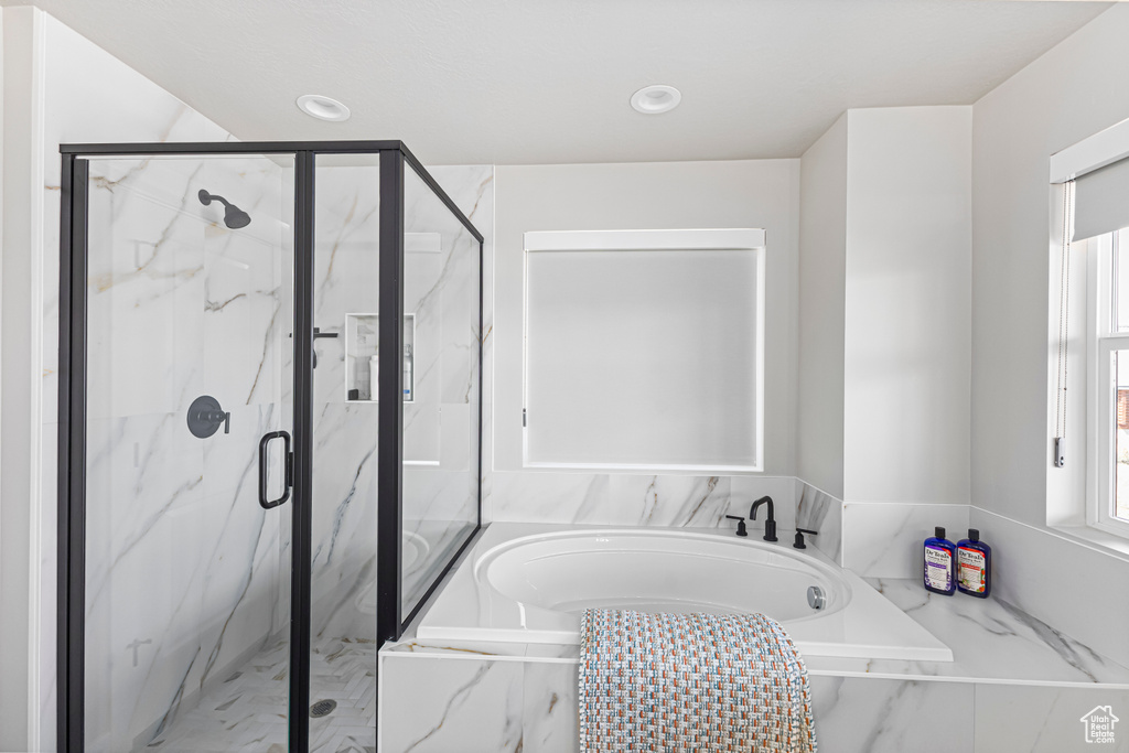 Bathroom with a garden tub, marble finish floor, a marble finish shower, and recessed lighting
