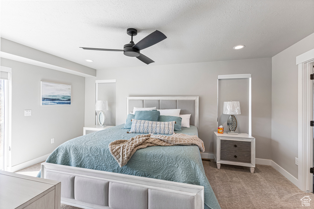 Carpeted bedroom featuring baseboards, ceiling fan, recessed lighting, and a textured ceiling
