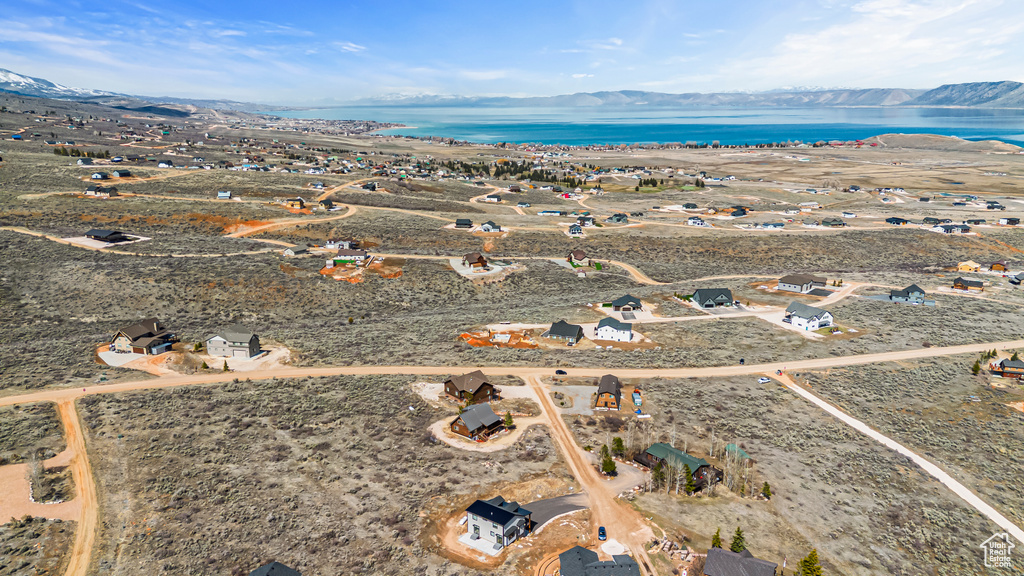 Birds eye view of property featuring a water and mountain view