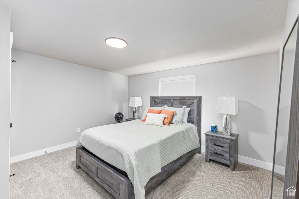 Bedroom featuring carpet floors and baseboards