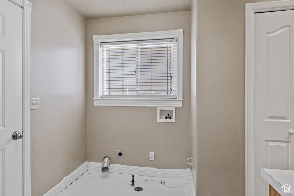 Clothes washing area featuring washer hookup, laundry area, and electric dryer hookup