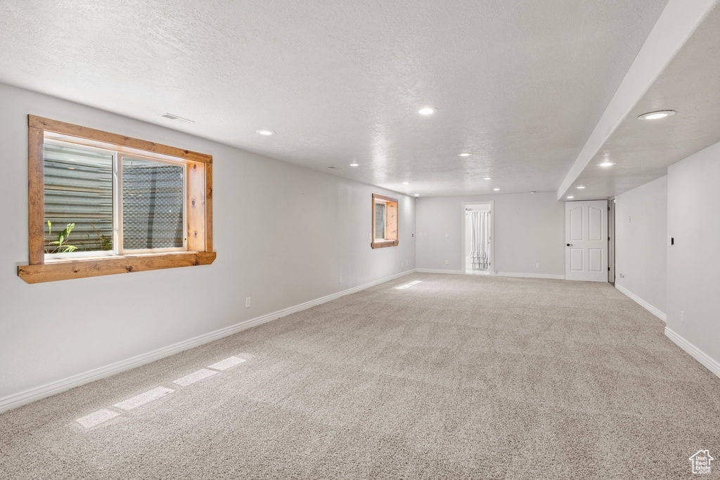 Spare room with baseboards, light carpet, recessed lighting, and visible vents