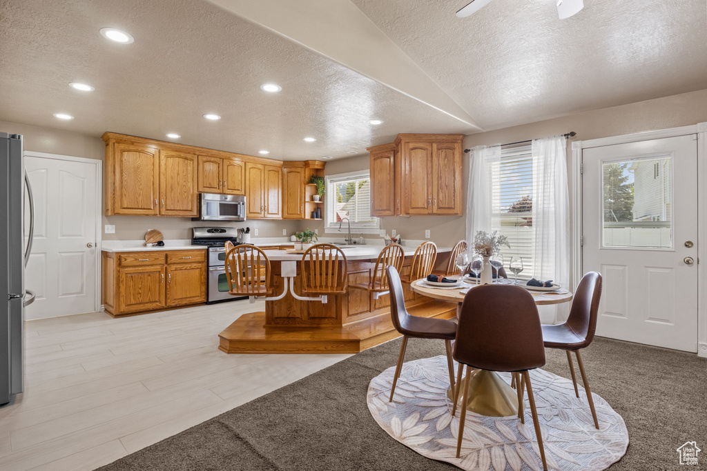 Dining room with recessed lighting and a textured ceiling