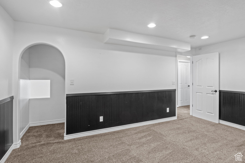 Unfurnished room featuring wainscoting, carpet flooring, and recessed lighting