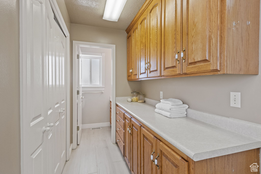 Interior space featuring baseboards and a textured ceiling