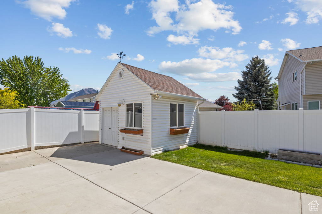View of outbuilding with a fenced backyard and an outbuilding