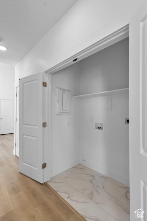 Laundry room featuring laundry area, marble finish floor, baseboards, hookup for a washing machine, and electric dryer hookup