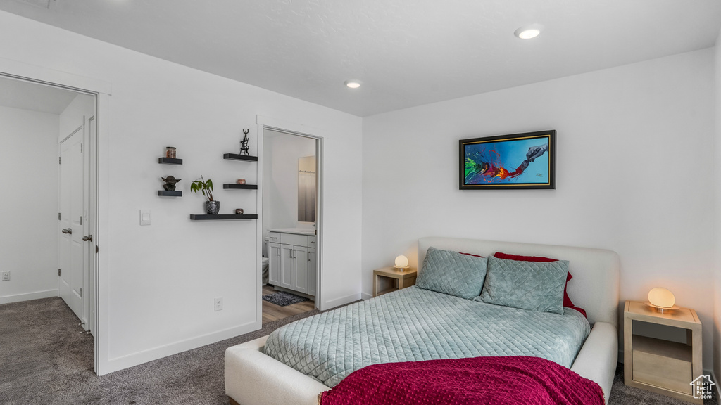 Carpeted bedroom featuring baseboards, recessed lighting, and ensuite bath