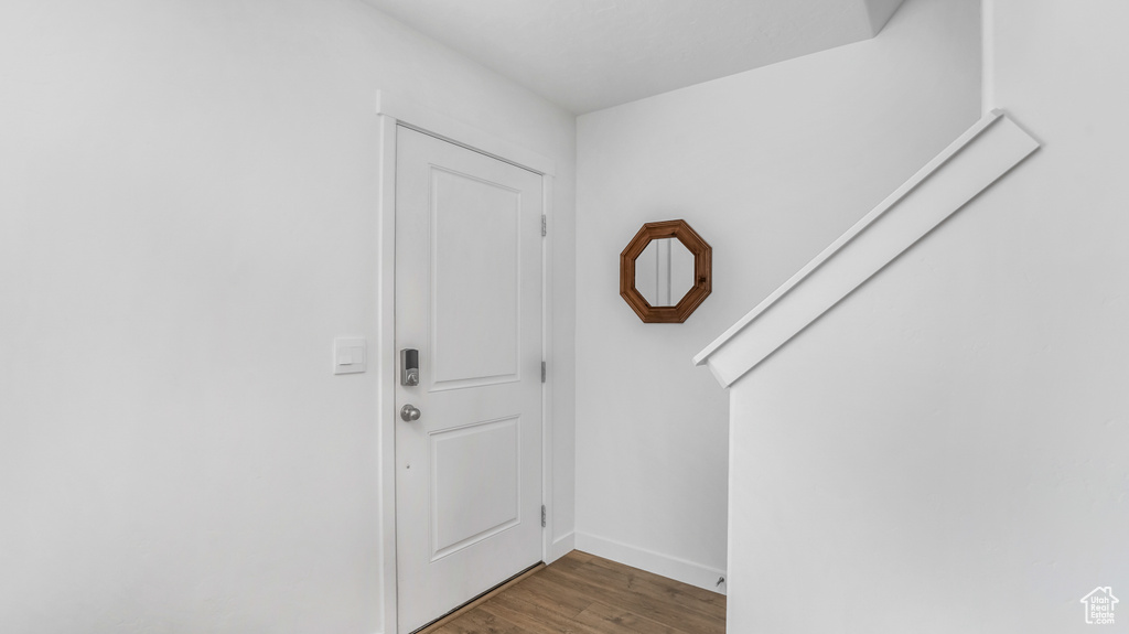 Foyer entrance featuring baseboards and wood finished floors