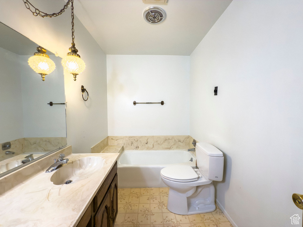 Full bath featuring visible vents, vanity, toilet, a bath, and tile patterned floors