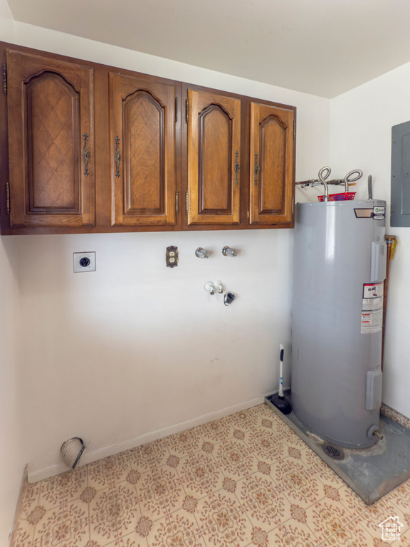 Laundry room with baseboards, electric water heater, electric dryer hookup, cabinet space, and washer hookup