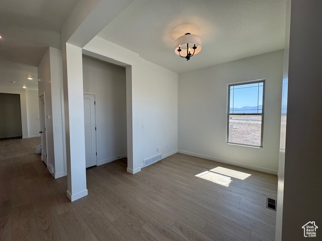 Unfurnished bedroom with wood finished floors, baseboards, and recessed lighting