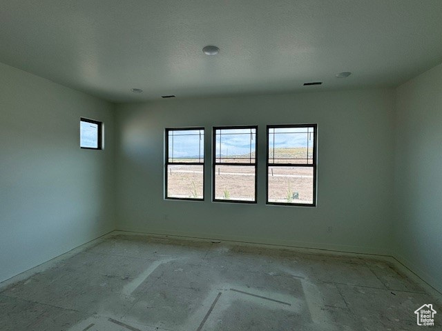 Spare room featuring baseboards