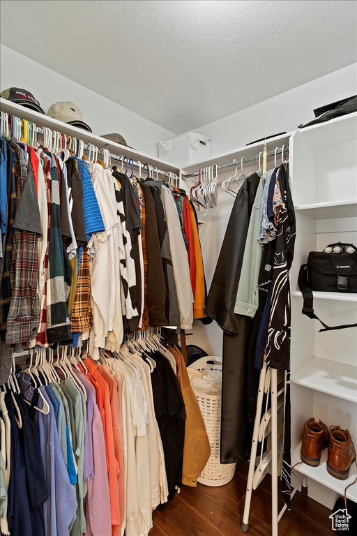 Walk in closet featuring wood finished floors