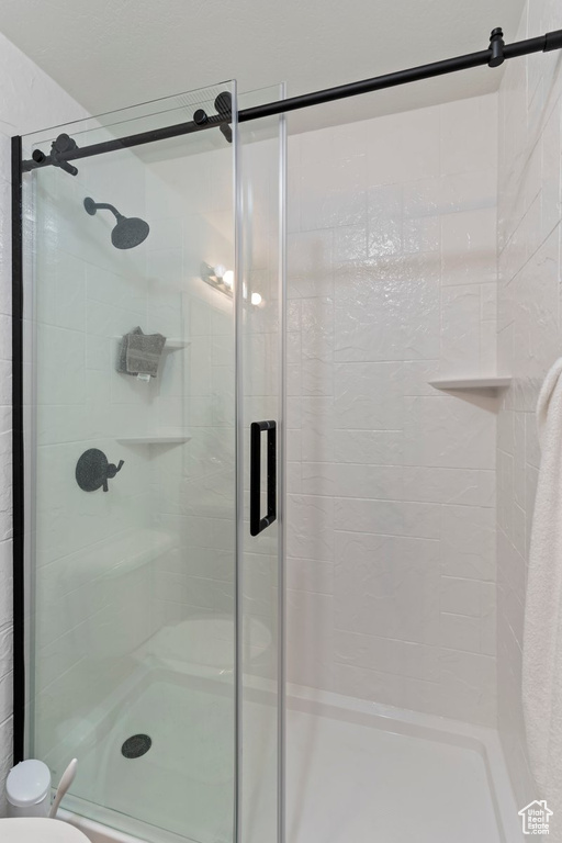 Bathroom featuring a stall shower and toilet