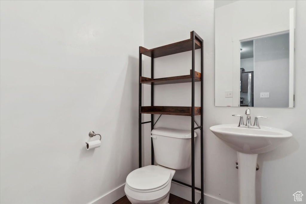 Bathroom featuring toilet and baseboards
