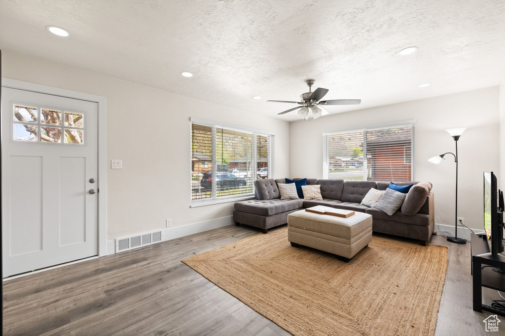 Living room featuring a healthy amount of sunlight, a textured ceiling, and visible vents