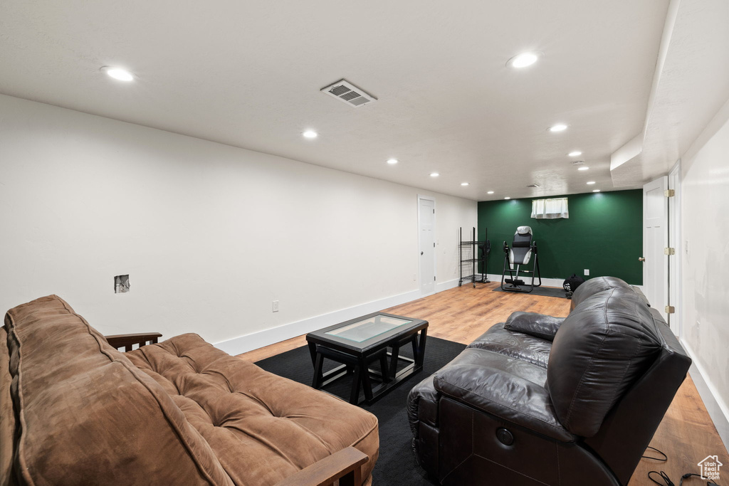 Living room featuring recessed lighting, baseboards, visible vents, and wood finished floors