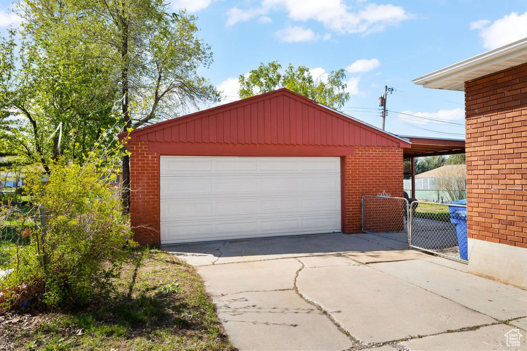Detached garage featuring fence