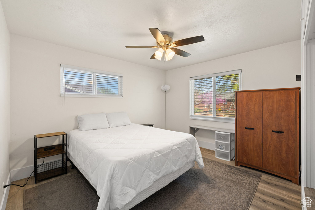 Bedroom featuring ceiling fan and wood finished floors