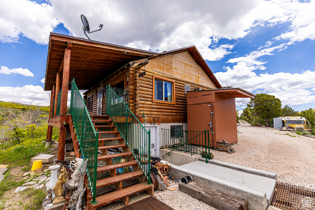 Exterior space featuring stairs and log siding