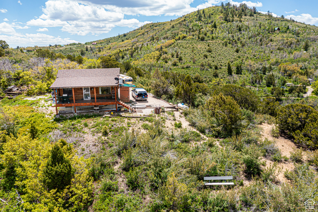 Birds eye view of property featuring a wooded view and a mountain view