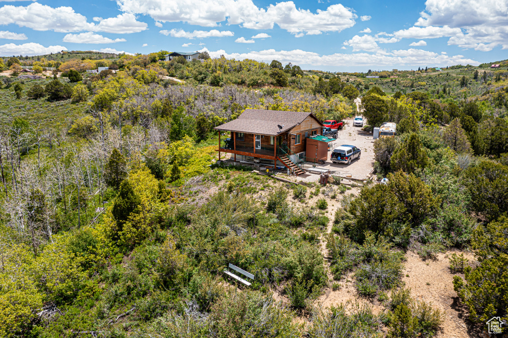 Birds eye view of property featuring a view of trees