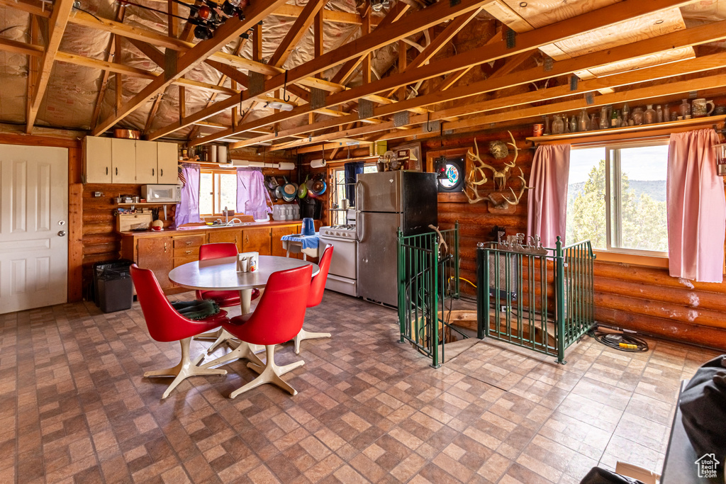 Dining room featuring brick patterned floor