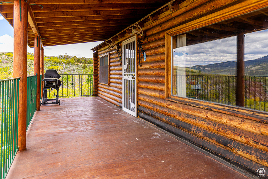 View of patio with a mountain view and area for grilling