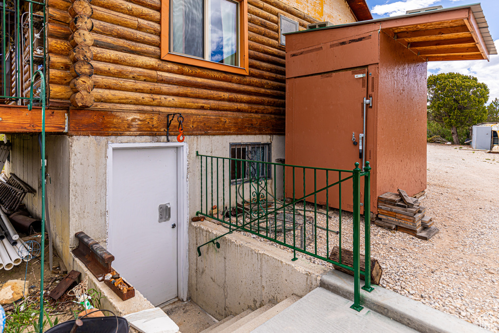 Property entrance with log siding