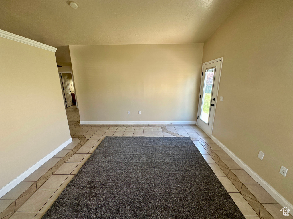 Unfurnished room featuring baseboards and light tile patterned floors