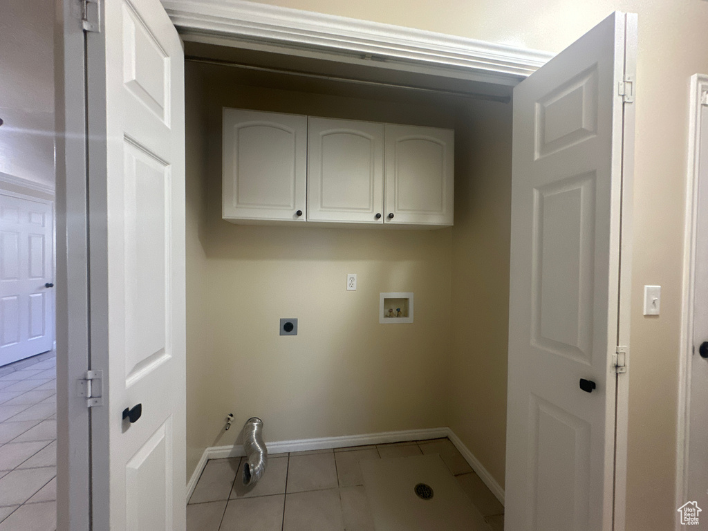 Laundry room with laundry area, light tile patterned flooring, baseboards, electric dryer hookup, and washer hookup