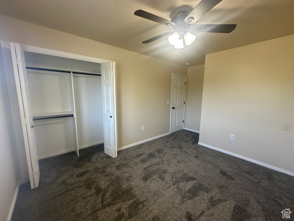 Unfurnished bedroom with baseboards, carpet, ceiling fan, and a closet